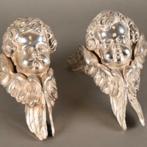 Deux têtes d'anges en argent