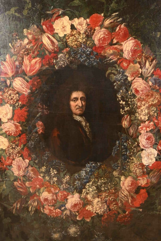 Portrait d'un homme en oval entouré d'une couronne de fleurs