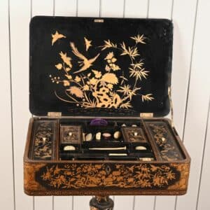 Travailleuse en bois laqué et doré à décor de scènes pittoresques chinoises.